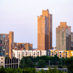 Riverside Plaza, a defining feature of the Cedar-Riverside neighborhood in Minneapolis, reflects the city’s 1970s experiment with large-scale urban housing. Designed by architect Ralph Rapson and completed in 1973, the complex was built as part of the federal urban renewal program and stands out for its Brutalist concrete design and colorful panels. Often referred to locally as “Little Mogadishu” due to its large Somali community, the towers remain a prominent symbol of both the city’s architectural ambition and its layered immigrant history.