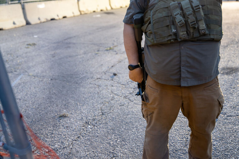 Security at Seven Points Mall following Winston Smith protests 2 Armed security from Conflict Resolution Group inside a fence at Seven Points Mall. The area was the site of protests following the killing of Winston Smith by federal law enforcement officers the month earlier.