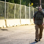 A security guard with Conflict Resolution Group wearing a CRG patch at Seven Points Mall in Uptown Minneapolis.