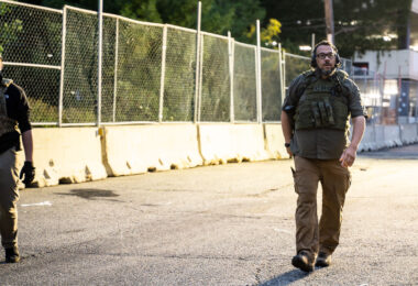 A security guard with Conflict Resolution Group wearing a CRG patch at Seven Points Mall in Uptown Minneapolis.