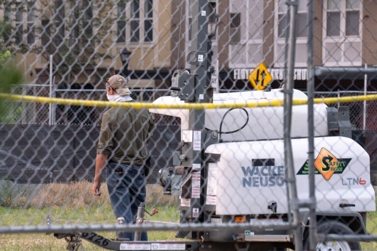 Security guard with face covering in Minneapolis 3 A security guard at Seven Points Mall with a face covering turns his back.