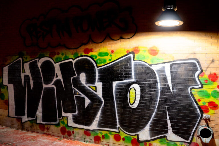 Winston Smith mural in Uptown Minneapolis 3 Winston written on the side of the building next to the Deona Marie memorial.