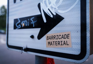 A sticker reading "BARRICADE MATERIAL" referring to the heavy use of just about anything available to create barricades in the streets during unrest.