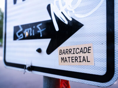Minneapolis: "Barricade Material" Sticker on Sign