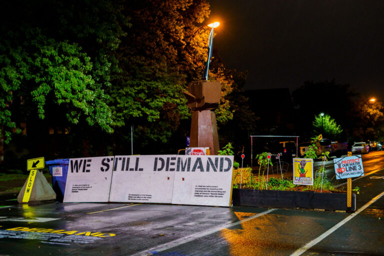 Rain falls at George Floyd Square 1 Street barricades on Chicago Avenue in August 2021.