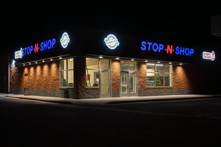 The Stop-N-Shop gas station and convenience store in South Minneapolis is shown here after undergoing repairs. The building, located across from the Minneapolis Police Department's Fifth Precinct, was damaged during the civil unrest that followed the murder of George Floyd in May 2020. The unrest led to widespread protests and property damage throughout the city. This establishment serves as a local business providing essential goods and services to the surrounding community.