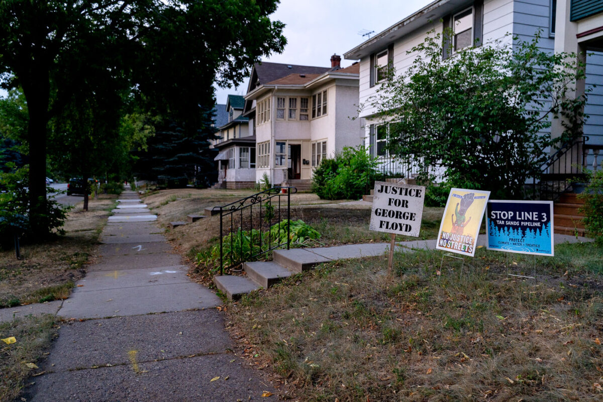 The wooden "Justice For George Floyd" signs sit in front yards of many homes on Park Avenue near George Floyd Square.