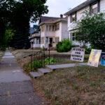 The wooden "Justice For George Floyd" signs sit in front yards of many homes on Park Avenue near George Floyd Square.