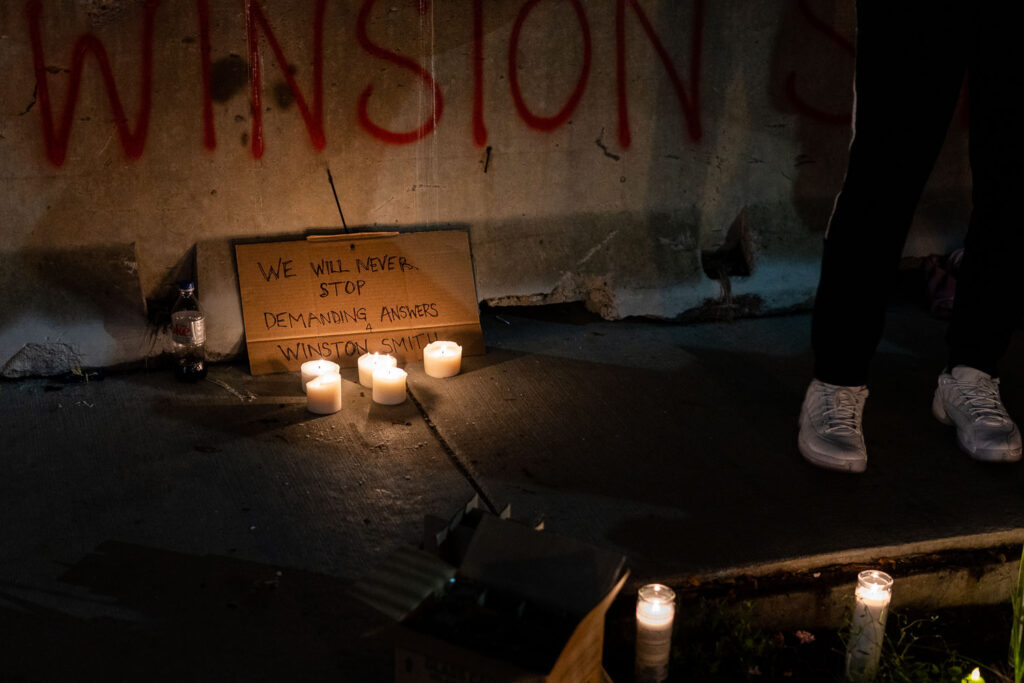 A vigil is held for Winston Smith who was killed by law enforcement 3 months earlier on this day.