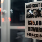 A poster hanging in a storefront asking for help in solving shootings of 3 children during the Spring of 2021 in North Minneapolis. 6-year old Aniya Allen, 9-year old Trinity Ottoson-Smith and 10-year old Ladavionne Garret Jr. Trinity and Aniya died of their injuries.