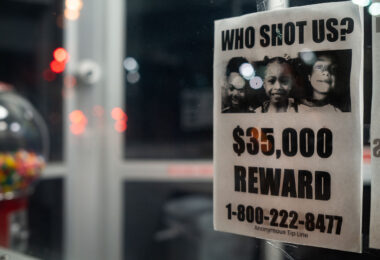 A poster hanging in a storefront asking for help in solving shootings of 3 children during the Spring of 2021 in North Minneapolis. 6-year old Aniya Allen, 9-year old Trinity Ottoson-Smith and 10-year old Ladavionne Garret Jr. Trinity and Aniya died of their injuries.