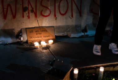 A vigil is held for Winston Smith who was killed by law enforcement 3 months earlier on this day.