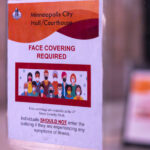 Face Covering RequiredA sign seen at Minneapolis City Hall. It states individuals should not enter the building if they are experiencing any symptoms of illness.