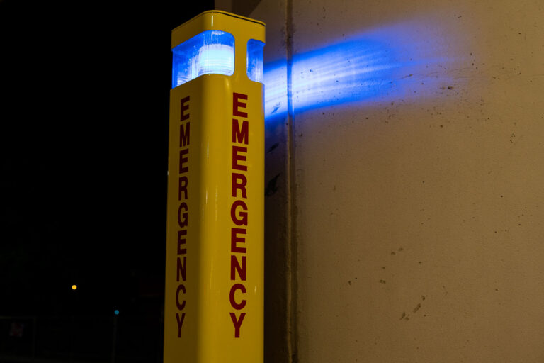 Emergency Sign at Bus Station 1 Commonly found on university campuses and parking structures, these stations serve as silent sentinels—symbols of safety, vigilance, and modern urban design meant to provide immediate access to help in isolated spaces.