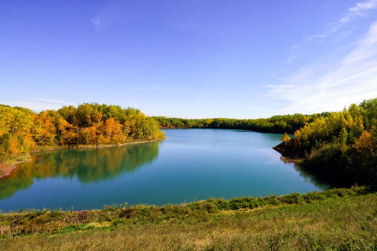 Flooded Wacootah Mine Pit, Mountain Iron 2 Water-filled Wacootah Mine pit surrounded by autumn forest near Mountain Iron, Minnesota.