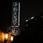 The sign at the Gatsby apartment building in Minneapolis at night.