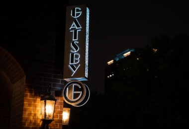 The sign at the Gatsby apartment building in Minneapolis at night.