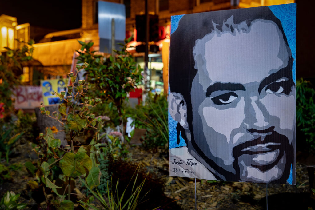 A poster for Justin Teigen inside the George Floyd Memorial in George Floyd Square.
