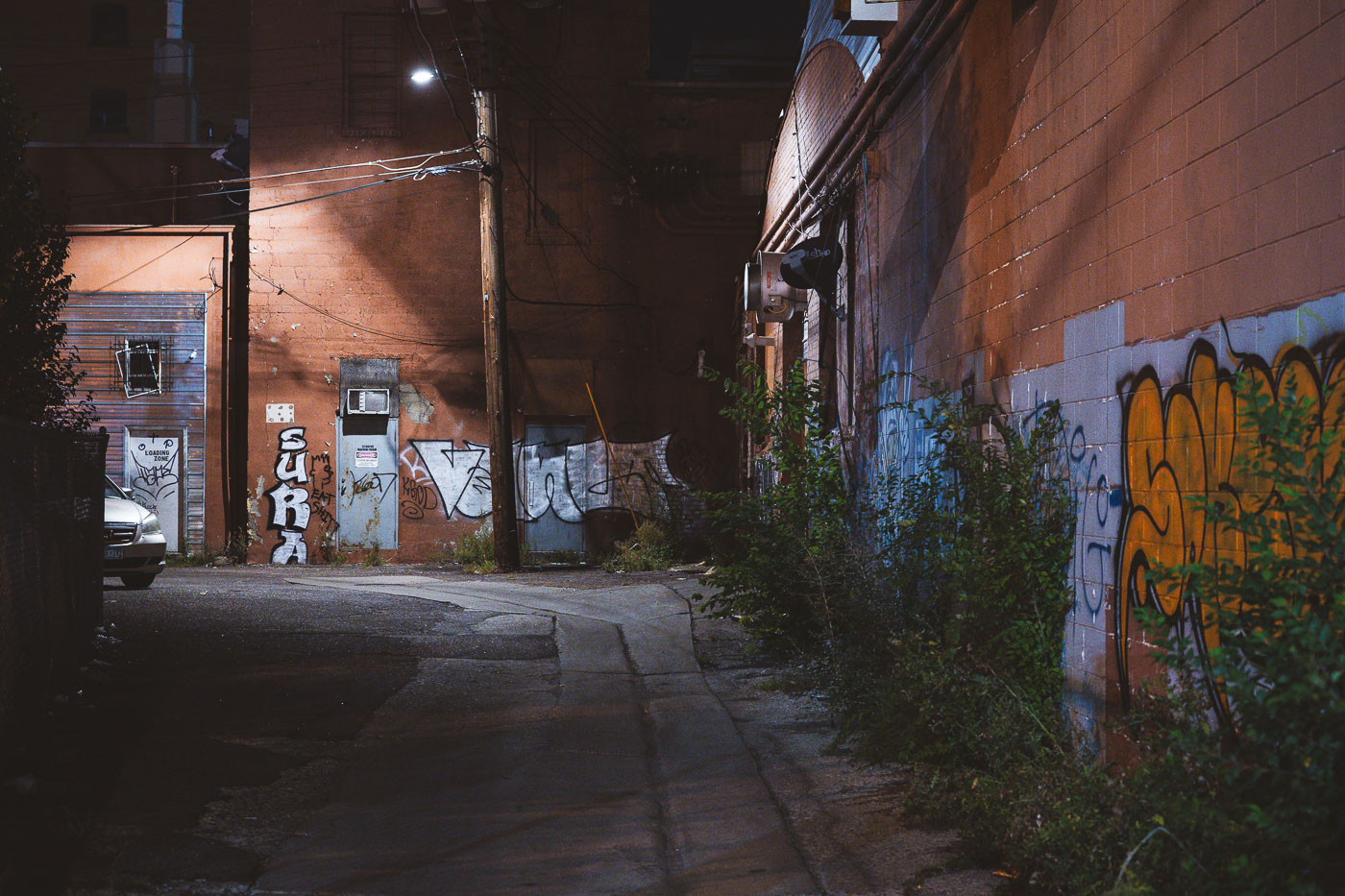 Graffiti covers the walls of an alleyway off Lake Street in South Minneapolis, photographed in September 2021. Alleys often serve as service corridors and informal spaces for expression.
