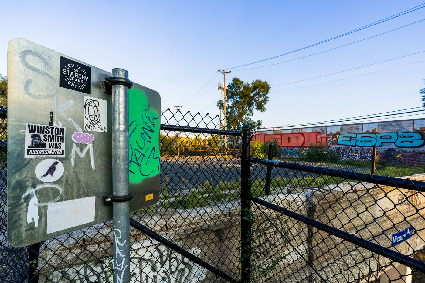 A sticker referencing Winston Smith is affixed to a sign along the Midtown Greenway in Minneapolis, Minnesota.