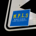 A M.P.L.S. Money Power Land Solidarity sticker found in South Minneapolis.