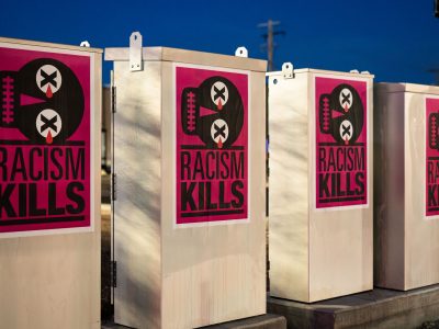 Racism Kills posters on Minneapolis Midtown Greenway electrical boxes