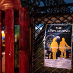 A flyer for The Unplugging by New Native Theatre at the site of the former Gandhi Mahal Site that burned down during unrest.