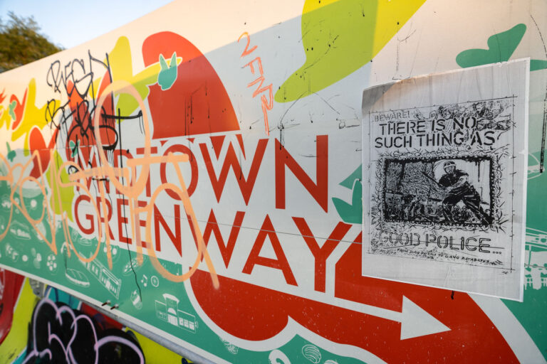 There is no such thing as good police poster 1 A sign leading to the Midtown Greenway in South Minneapolis.