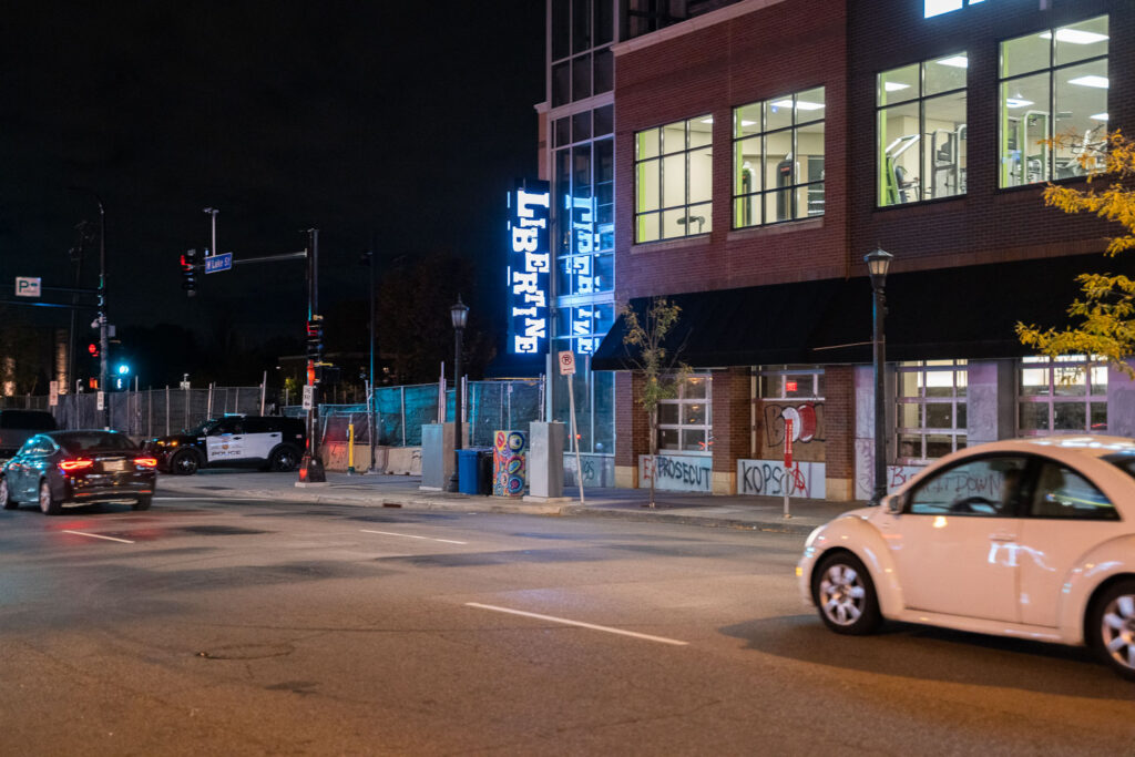 A police officer parks outside of the Lake & Girard parking ramp.