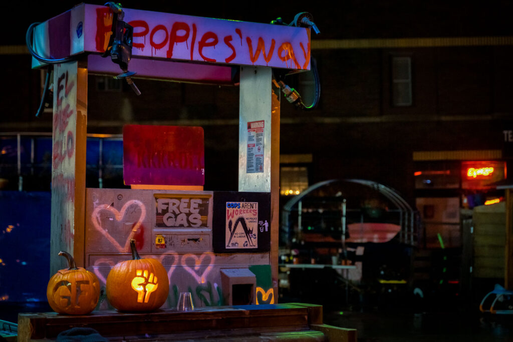 GFS and fist pumpkin carvings at Peoples Way in George Floyd Square.