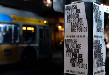Posters hanging on a street pole in Uptown Minneapolis. They read “Abolish the police” “We keep us safe”. The posters hang outside the parking ramp that Winston Smith was killed at in June by federal law enforcement.