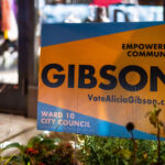 A campaign sign for Alicia Gibson stands outside a neighborhood storefront in Minneapolis’ Ward 10, a district centered on Uptown, Whittier, and parts of South Minneapolis. Ward 10 has long been one of the city’s most politically active areas, shaped by rental-heavy housing stock, transit-focused neighborhoods, and dense commercial corridors around Hennepin, Lyndale, and Lake Street. Campaign signs became common across the ward during the municipal election cycle as candidates addressed issues central to this part of the city: small-business recovery, housing policy, cycling and pedestrian infrastructure, and the future of Uptown’s commercial identity.

Historically, Ward 10 has been a bellwether for broader citywide political shifts. Its mix of long-term residents, young renters, and small-business owners has kept competition high and civic turnout strong. In recent years, community debates over zoning updates, transportation improvements, and neighborhood redevelopment have made Ward 10 races especially watched, with campaigns frequently engaging directly with street-level concerns and neighborhood-driven organizing.