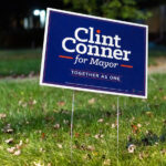 Clint Conner Mayoral Campaign Sign, Minneapolis 4 A lawn sign supporting Clint Conner’s mayoral campaign stands along a residential boulevard in Minneapolis. Conner, an attorney and political newcomer, ran on a platform focused on public safety reforms, neighborhood-level engagement, and governance changes within the city’s mayor–council structure. Yard signs like this became common across parts of Minneapolis during the campaign cycle, reflecting heightened civic interest following several years of intense debate over public safety, police restructuring, and the future of city governance.
Municipal elections in Minneapolis often draw regional attention due to the city’s distinctive political climate, strong neighborhood identities, and history of competitive mayoral contests. Candidate signage has long been a visible part of the city’s election seasons—especially in the years after 2020, when local races increasingly intersected with national conversations about public policy and urban leadership.