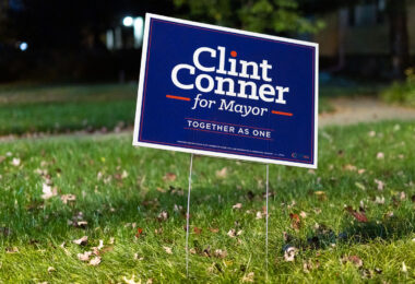 A lawn sign supporting Clint Conner’s mayoral campaign stands along a residential boulevard in Minneapolis. Conner, an attorney and political newcomer, ran on a platform focused on public safety reforms, neighborhood-level engagement, and governance changes within the city’s mayor–council structure. Yard signs like this became common across parts of Minneapolis during the campaign cycle, reflecting heightened civic interest following several years of intense debate over public safety, police restructuring, and the future of city governance.

Municipal elections in Minneapolis often draw regional attention due to the city’s distinctive political climate, strong neighborhood identities, and history of competitive mayoral contests. Candidate signage has long been a visible part of the city’s election seasons—especially in the years after 2020, when local races increasingly intersected with national conversations about public policy and urban leadership.