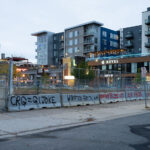 Graffiti on the side of concrete barricades that surround the parking garage that Winston Smith was killed by law enforcement on June 3rd, 2021.CRG=GI Joke. CRG refers to private security company Conflict Resolution Group.