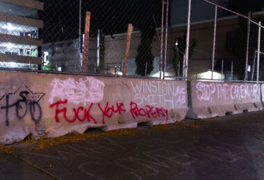 Graffiti on concrete barriers around the parking garage where Winston Smith was killed on June 3rd, 2021 by law enforcement.