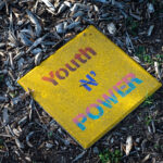 "Youth N' Power" written on a stone near the Say Their Names Memorial at George Floyd Square.