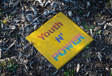 "Youth N' Power" written on a stone near the Say Their Names Memorial at George Floyd Square.