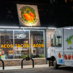 Habanero Tacos Grill glows along East Lake Street late into the evening, with its bright “TACOS TACOS TACOS” window lettering and a branded food truck parked out front. The restaurant reflects the long-standing presence of Latino food culture on the corridor, where small family-run kitchens, taquerías, and mobile food vendors have shaped the visual and culinary identity of the neighborhood.

Located along a stretch of Lake Street known for immigrant-owned businesses and tightly packed storefronts, the shop sits within a commercial landscape rebuilt and revitalized multiple times over the past century. Despite economic shifts and recent reconstruction efforts, the area remains a hub of diverse restaurants and community-oriented businesses, with places like Habanero Tacos Grill continuing to anchor the corridor’s daily life.