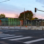 The Minneapolis Police Fifth Precinct with security fencing and concrete barricades surrounding it.