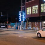 A police officer parks outside of the Lake & Girard parking ramp.