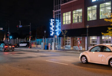 A police officer parks outside of the Lake & Girard parking ramp.