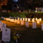 Minneapolis police squad cars and an ambulance behind Say Their Names Cemetery at George Floyd Square.