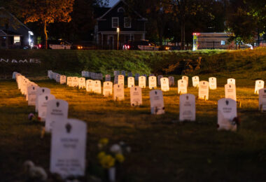 Minneapolis police squad cars and an ambulance behind Say Their Names Cemetery at George Floyd Square.