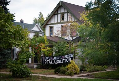A home with a "No Cops, No Judges, No Prison Total Abolition" banner on their home during Open Streets Lyndale 2021.