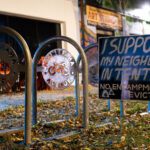"I support my neighbors in tents. No encampment evictions" yard sign on Minnehaha Avenue.
