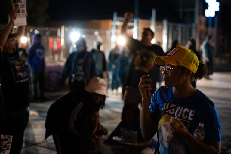 Protesters with megaphone in Uptown Minneapolis 4 Protesters at Lake & Girard on the 4 month anniversary of Winston Smith's death. Smith was killed by federal law enforcement on top of the parking garage at Lake and Girard.