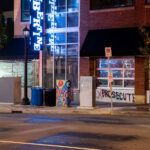 Outside of the parking garage where Winston Smith was killed on June 3rd. New security fencing and wrap installed.
