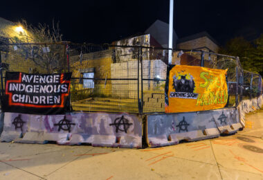 "Avenge Indigenous Children" and “Spirit Halloween" banners on the former Minneapolis Police Third Precinct. The police station was burned during protests that followed the May 25th, 2020 murder of George Floyd.