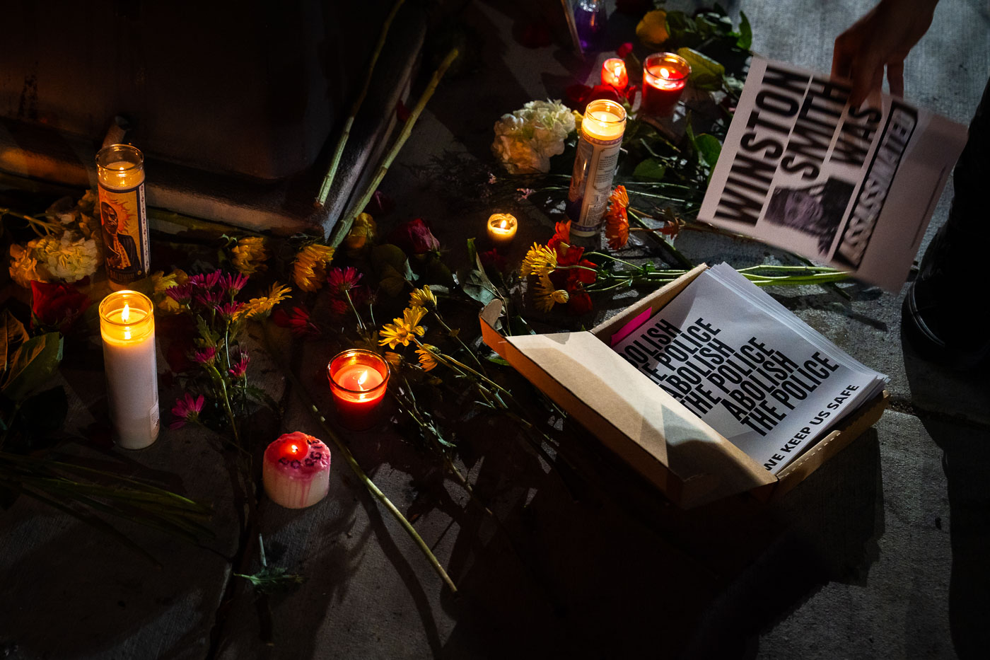 Vigil in Minneapolis with Abolish The Police protest flyers